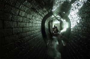 Personal kneeling in stone tunnel, photo credit jondoe via flickr
